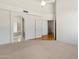 Spacious main bedroom with en-suite bathroom, neutral carpet, and stairs access at 4446 E Woodridge Dr, Phoenix, AZ 85032