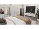 Bright bedroom with an ensuite bathroom and staircase entrance, featuring a mounted television at 4446 E Woodridge Dr, Phoenix, AZ 85032