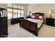 Serene main bedroom featuring a large window, dark furniture, and a comfortable bed with elegant linens at 4446 E Woodridge Dr, Phoenix, AZ 85032