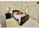 Cozy main bedroom with a large window, dark wood furniture, and a comfortable bed with neutral decor at 4446 E Woodridge Dr, Phoenix, AZ 85032