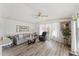 Inviting living room with wood floors, ceiling fan, a comfortable sofa, and plenty of natural light from large windows at 5735 E Mcdowell Rd # 147, Mesa, AZ 85215