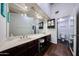 Bathroom featuring a vanity with granite counter and wood cabinets, accompanied by a comfort height toilet at 6533 N 10Th Pl, Phoenix, AZ 85014
