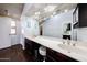 Bathroom with dual sinks, large mirror, dark wood cabinets, and modern lighting at 6533 N 10Th Pl, Phoenix, AZ 85014