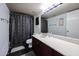 Cozy bathroom with a granite counter vanity, stainless steel faucet and black and white accent tile flooring at 6533 N 10Th Pl, Phoenix, AZ 85014