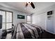 Neutral bedroom with a ceiling fan, large windows, and a spacious closet at 6533 N 10Th Pl, Phoenix, AZ 85014