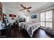 Spacious bedroom featuring wood floors, a large window, ceiling fan, and ample storage at 6533 N 10Th Pl, Phoenix, AZ 85014