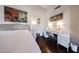 Bright and spacious main bedroom with desk area, wood floors, and calming beach scene artwork at 6533 N 10Th Pl, Phoenix, AZ 85014