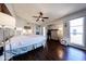 Bright main bedroom featuring dark floors, ceiling fan, and an abundance of natural light at 6533 N 10Th Pl, Phoenix, AZ 85014