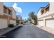 Quiet street featuring townhomes with garages, mature trees, and well-maintained landscaping at 6533 N 10Th Pl, Phoenix, AZ 85014