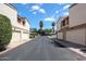 Neighborhood street with townhomes featuring garages, landscaping, and mature palm trees at 6533 N 10Th Pl, Phoenix, AZ 85014