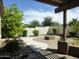 Lush backyard with pavers, fireplace, manicured shrubs, plants, and partial pergola at 6687 S Banning St, Gilbert, AZ 85298