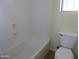Clean bathroom with shower and tub combo and modern toilet and fixtures at 6687 S Banning St, Gilbert, AZ 85298