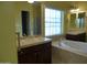 Relaxing primary bathroom with separate vanities, soaking tub, and walk-in shower at 6687 S Banning St, Gilbert, AZ 85298