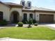 Charming single-story home featuring a well-manicured lawn and a two-car garage at 6687 S Banning St, Gilbert, AZ 85298
