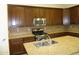 Modern kitchen featuring dark wood cabinets, granite counters, and stainless steel appliances at 6687 S Banning St, Gilbert, AZ 85298