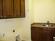 Functional laundry room featuring ample cabinet space and a utility sink at 6687 S Banning St, Gilbert, AZ 85298