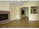 Cozy living room with fireplace, tile floors, and views into the connected kitchen at 6687 S Banning St, Gilbert, AZ 85298