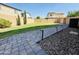 Well-maintained backyard with lush green lawn and charming paver pathway at 7312 S 13Th Way, Phoenix, AZ 85042