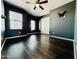 Spacious bedroom with hardwood floors, ceiling fan, and double window, offering ample natural light at 7312 S 13Th Way, Phoenix, AZ 85042