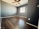 Bedroom featuring hardwood floors, a ceiling fan, neutral walls, and a window at 7312 S 13Th Way, Phoenix, AZ 85042
