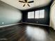 Bedroom featuring hardwood floors, a ceiling fan, and a double window, offering ample natural light at 7312 S 13Th Way, Phoenix, AZ 85042