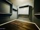 Walk-in closet featuring custom shelving, wood-look flooring, and ample storage space at 7312 S 13Th Way, Phoenix, AZ 85042