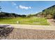 A green community park featuring lush grass, mature trees, a gazebo, and walking paths under a sunny, blue sky at 7312 S 13Th Way, Phoenix, AZ 85042