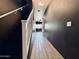 Hallway with wood-look tile flooring, stairs, and neutral-colored walls at 7312 S 13Th Way, Phoenix, AZ 85042