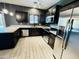 Updated kitchen featuring stainless steel appliances and light granite countertops and dark cabinets at 7312 S 13Th Way, Phoenix, AZ 85042