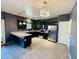 Stylish kitchen area featuring a breakfast bar, granite countertops, and stainless steel appliances at 7312 S 13Th Way, Phoenix, AZ 85042