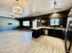 Open kitchen and living room featuring black cabinets, granite countertops and stainless steel appliances at 7312 S 13Th Way, Phoenix, AZ 85042