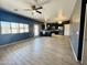 Open-concept living room with hardwood floors, connecting to a stylish kitchen and dining area at 7312 S 13Th Way, Phoenix, AZ 85042