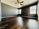 Large bedroom featuring a ceiling fan, hardwood floors, and natural light at 7312 S 13Th Way, Phoenix, AZ 85042