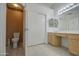 Bright bathroom features a toilet, vanity with light wood cabinets and a large sliding door linen closet at 863 S Del Rancho --, Mesa, AZ 85208