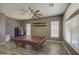 Versatile game room with gray wood-look floors, a large ceiling fan, and potential for entertainment at 863 S Del Rancho --, Mesa, AZ 85208