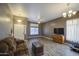 Spacious living room with modern gray wood-look flooring, ceiling fan, and a comfortable couch at 863 S Del Rancho --, Mesa, AZ 85208