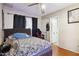 Bedroom with ceiling fan, black out curtains, laminate wood flooring, a queen bed and attached bath at 8724 N 28Th Ave, Phoenix, AZ 85051
