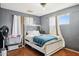 Bedroom with a tufted headboard, gray walls, and wood floors at 8724 N 28Th Ave, Phoenix, AZ 85051