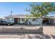 Charming single-story home with blue exterior, decorative rock yard and large covered carport at 8724 N 28Th Ave, Phoenix, AZ 85051