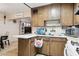 Retro kitchen featuring wood cabinets, white countertops, and an open layout at 8724 N 28Th Ave, Phoenix, AZ 85051