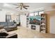 Spacious living room featuring a ceiling fan, tile flooring, and built-in entertainment center with fireplace at 8724 N 28Th Ave, Phoenix, AZ 85051