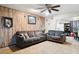 Cozy living room with ceiling fan, tile floors, wood paneling, and comfortable sofas at 8724 N 28Th Ave, Phoenix, AZ 85051