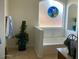 Bright bathroom with large arched window, soaking tub, decorative stained glass and a houseplant at 914 W Morelos St, Chandler, AZ 85225