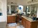 Bright bathroom featuring double vanity, wooden cabinets, framed mirrors and a decorative window at 914 W Morelos St, Chandler, AZ 85225