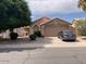 Tan single-story home with desert landscaping, large shade tree and a two-car garage at 914 W Morelos St, Chandler, AZ 85225