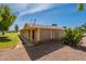 Back of house and outdoor living space showcasing a well-maintained yard and the home's rear elevation at 10644 W Campana Dr, Sun City, AZ 85351