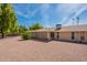 Wide shot of backyard and house showcasing a well-maintained yard and the home's rear elevation at 10644 W Campana Dr, Sun City, AZ 85351
