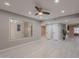 Bright bonus room with a ceiling fan, a large window, and light-colored wood-look floors at 10644 W Campana Dr, Sun City, AZ 85351
