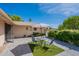 Private courtyard featuring stylish tile flooring and a modern table and chairs with lush landscaping at 10644 W Campana Dr, Sun City, AZ 85351