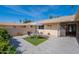 Inviting courtyard featuring a modern table and chairs on artificial turf and stylish tile flooring at 10644 W Campana Dr, Sun City, AZ 85351